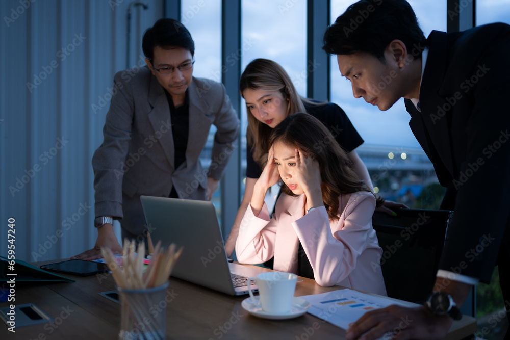Group of broker international stock traders working actively at night in office, A young woman is working hustle to present a client with friends helping her with information. Group of broker international stock traders working actively at night in office, A young woman is working hustle to present a client with friends helping her with information.