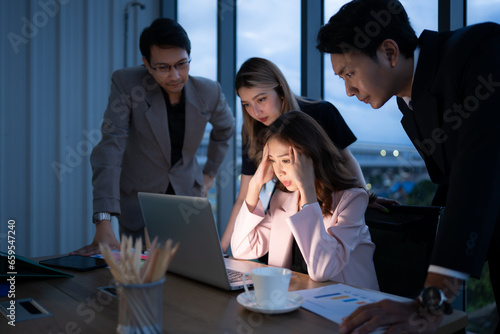 Group of broker international stock traders working actively at night in office, A young woman is working hustle to present a client with friends helping her with information.
