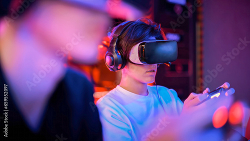 Teen playing a game console in VR