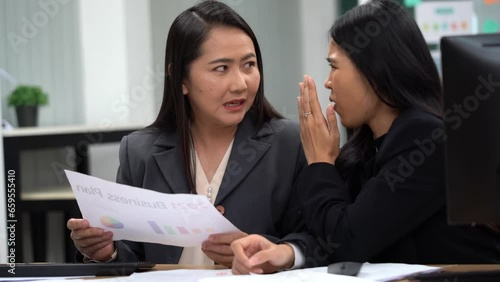 group of asian office worker woman talking or whispering gossip with colleague rumors to coworker in office photo