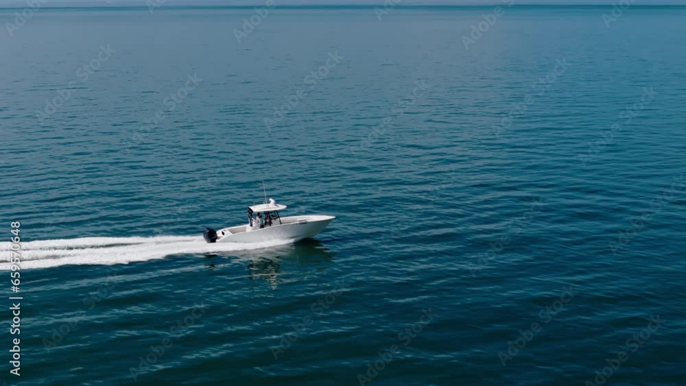 Drone wide view of a white boat sped sailing to the blue sea. moving at high speed. Drone wide view of a white boat sped sailing to the blue sea. moving at high speed.