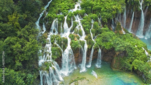 Tropical forest and mountain landscape with streams of water and waterfalls. Cascades flow among lush greenery in spring or summer.