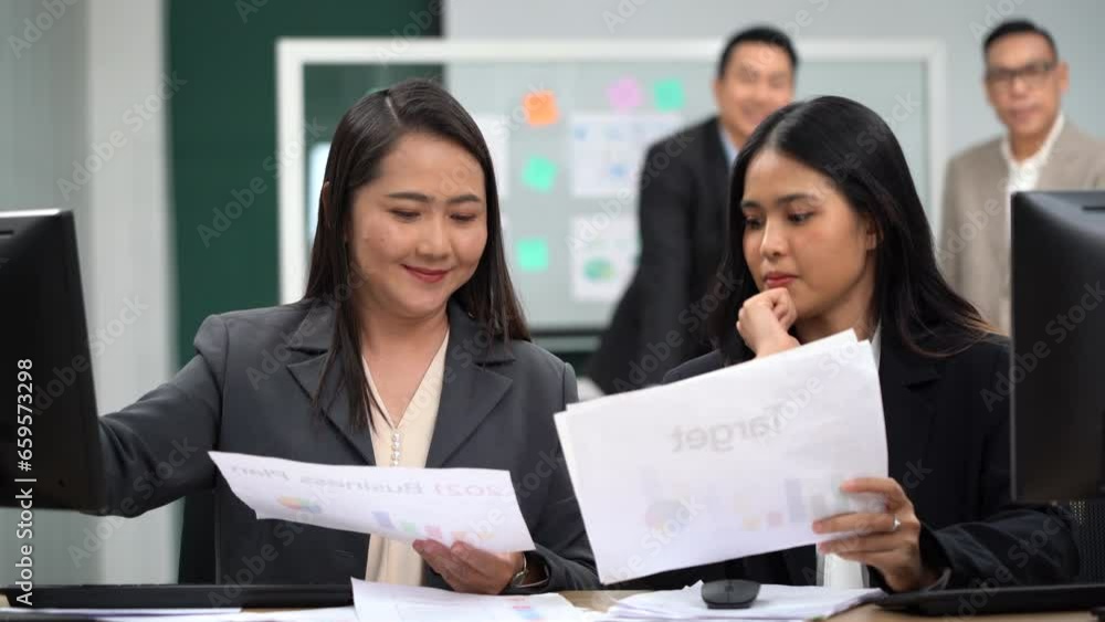 group of asian office worker woman talking and working with paper work and computer in office with colleague group of asian office worker woman talking and working with paper work and computer in office with colleague