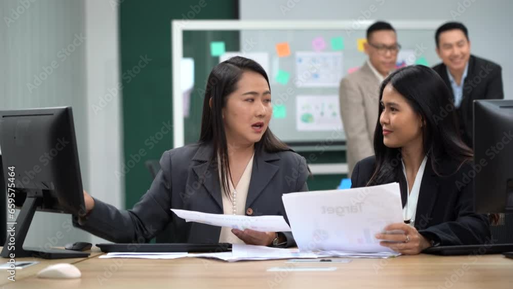 group of asian office worker woman talking and working with paper work and computer in office with colleague group of asian office worker woman talking and working with paper work and computer in office with colleague