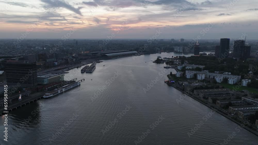 Aerial hyperlapse time lapse of the skyline of Amsterdam, The Netherlands at night. Central station, downtown Amsterdam. Ij river. Aerial hyperlapse time lapse of the skyline of Amsterdam, The Netherlands at night. Central station, downtown Amsterdam. Ij river.
