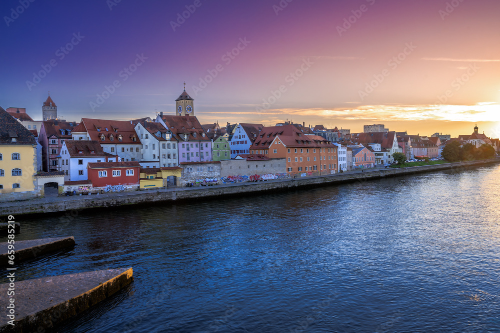 Cityscape of Regensburg at the river Daube during sunset