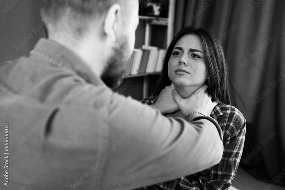 Man physically abusing his wife, victim of domestic violence. Stop physical abuse women concept. Black and white photo Man physically abusing his wife, victim of domestic violence. Stop physical abuse women concept. Black and white photo