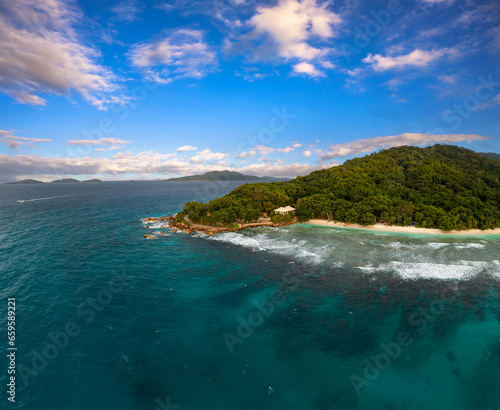 Aerial view of Anse Severe Beach at the La Digue Island, Seychelles. This beautiful white-sand beach is famous for its turquoise, shallow waters and sunset views. photo