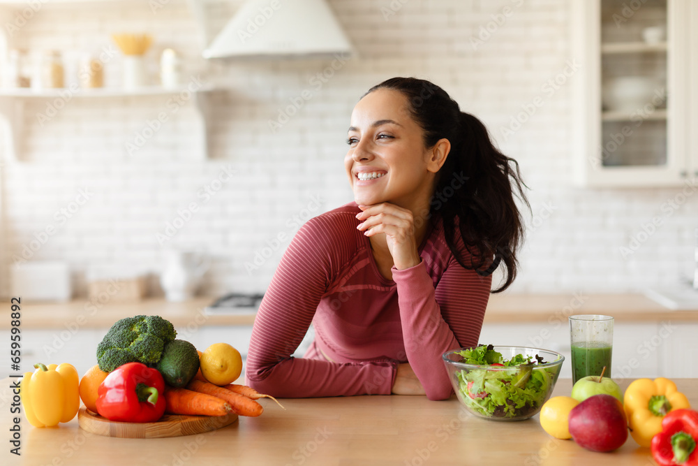 Sporty Fit Woman Standing Near Table With Vegetables At Kitchen