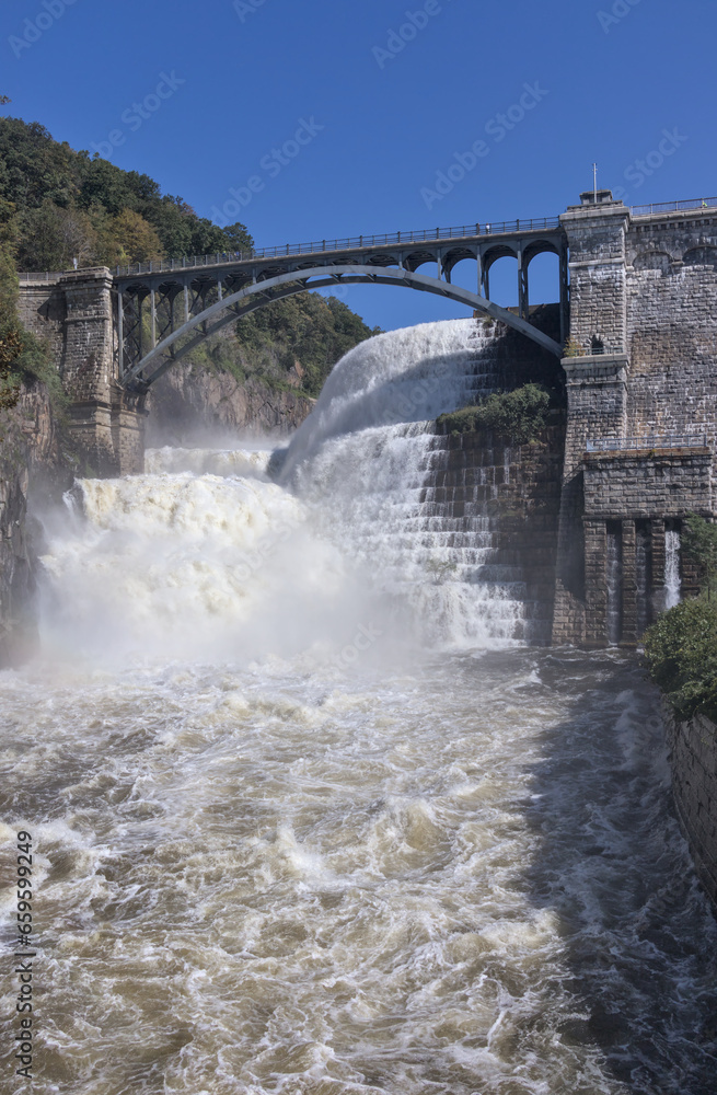 croton reservoir dam with bridge (natural and artifical waterfall in westchester, upstate new york) heavy flow of water croton reservoir dam with bridge (natural and artifical waterfall in westchester, upstate new york) heavy flow of water