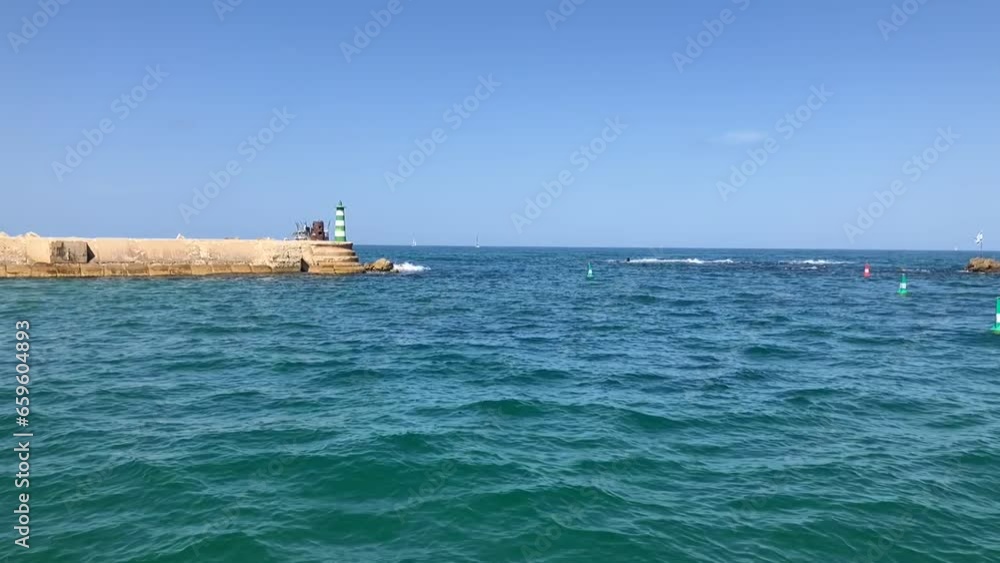 Lighthouse of Ancient Jaffa. Andromeda stones and the flag of Israel. Lighthouse of Ancient Jaffa. Andromeda stones and the flag of Israel.