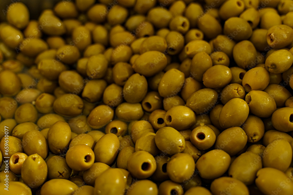 Seasoned olives in a container with marinate on the counter. Seasoned olives in a container with marinate on the counter.
