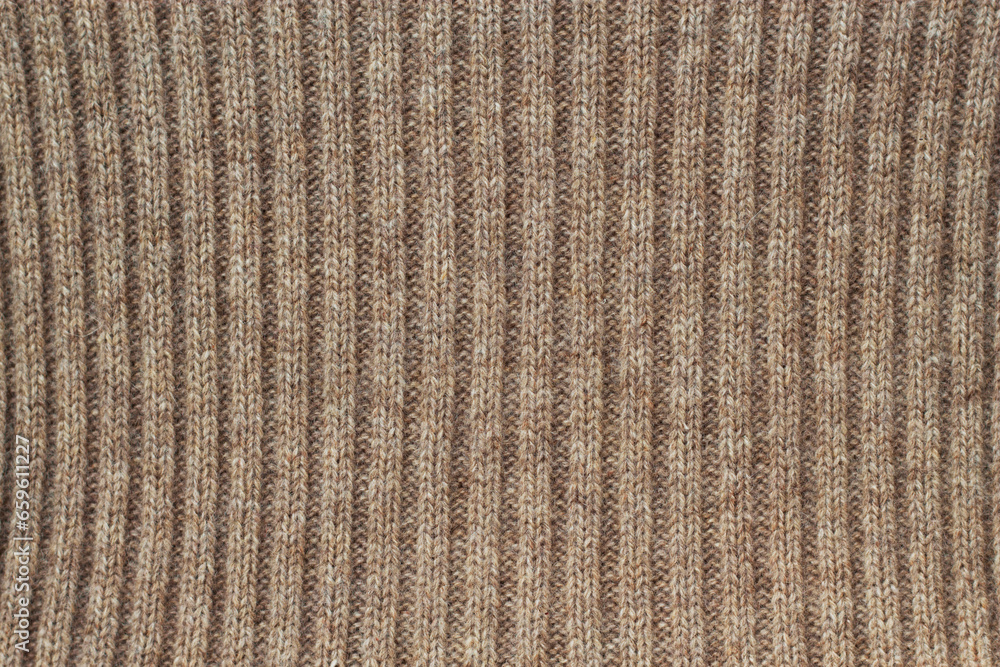 horizontal texture of a knitted beige woolen fabric as a warm background horizontal texture of a knitted beige woolen fabric as a warm background