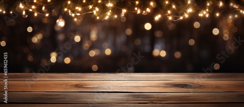 Wooden table with holiday lights in the evening photo