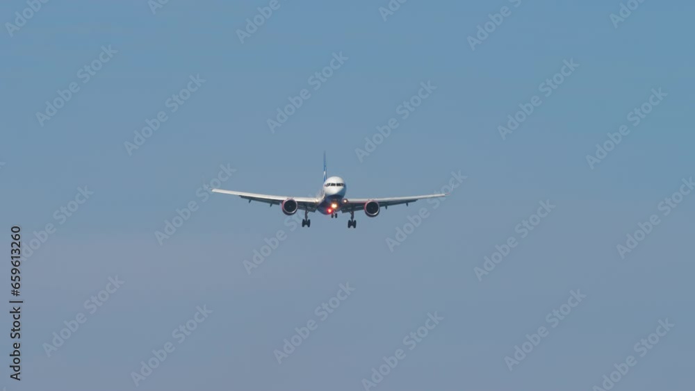 Jet in the sky, long shot. Airliner approaching to land. Commercial plane flies. Travel and tourism concept Jet in the sky, long shot. Airliner approaching to land. Commercial plane flies. Travel and tourism concept