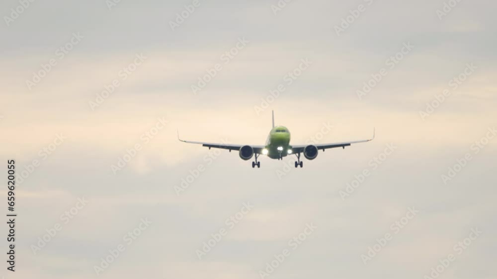 Jet plane approaching landing. Aircraft descending. Slow motion, airliner flying, front view Jet plane approaching landing. Aircraft descending. Slow motion, airliner flying, front view