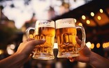 Two hands holding beer mugs and toasting