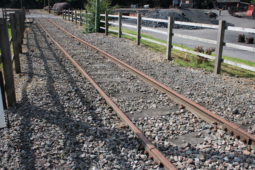 Tramway line with raised iron tramway tracks, gravel and fence enclosure Tramway line with raised iron tramway tracks, gravel and fence enclosure