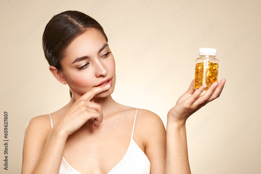 Vitamins. Close Up Of Happy Beautiful Girl With Pill With Cod Liver Oil Omega-3. Nutrition. Vitamin D, E, A Fish Oil Capsules. Healthy Lifestyle. Sport, Diet Concept - obrazy, fototapety, plakaty 