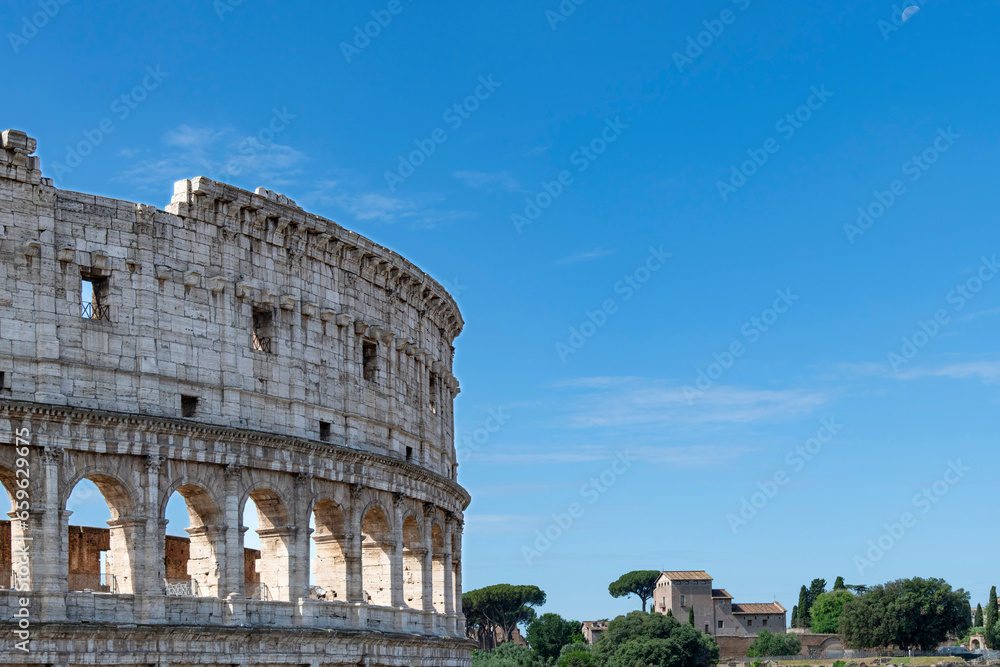 The Colosseum in Rome, Italy, an elliptical amphitheatre in the centre of the with the Roman Forum in the background