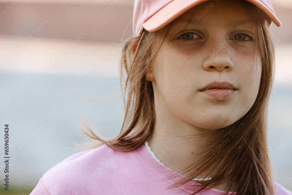 Close up portrait of a ten year old girl, smiling up at the camera. Positive emotion Close up portrait of a ten year old girl, smiling up at the camera. Positive emotion