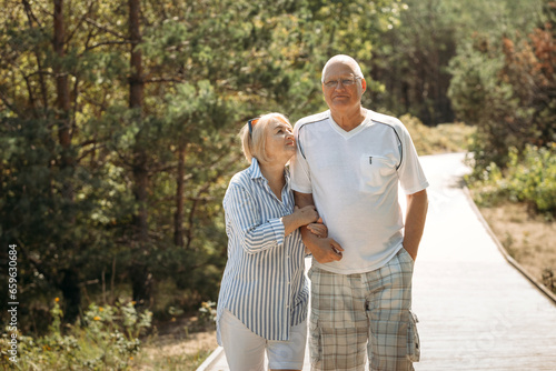 Portrait of a happy elderly couple on a path in the forest