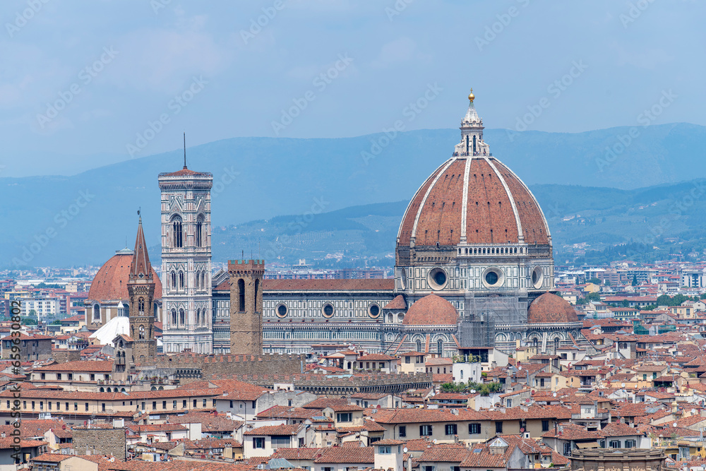 Cathedral of Santa Maria del Fiore in Piazza del Duomo, Florence, Italy seen in middle of city surrounded by typical houses with red roofs