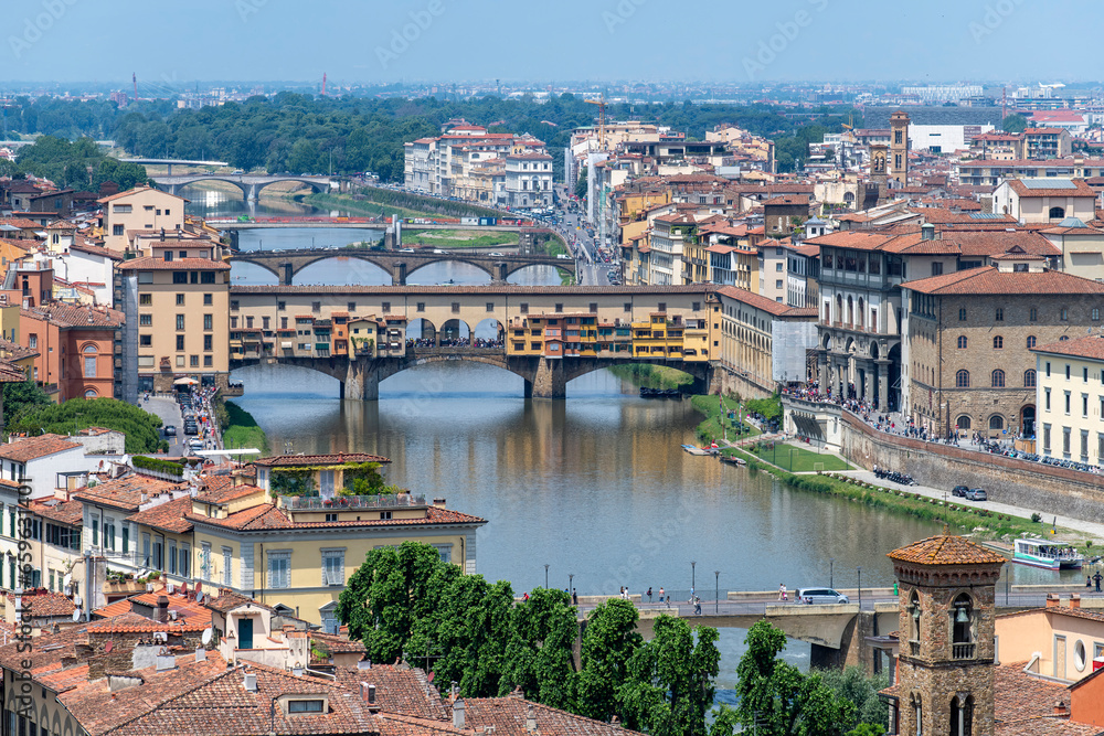 View over length of Arno River in Florence, Italy with a number of bridges crossing the river including Ponte Vecchio, Ponte Santa Trinita, Ponte alle Grazie and Ponte alla Carraia