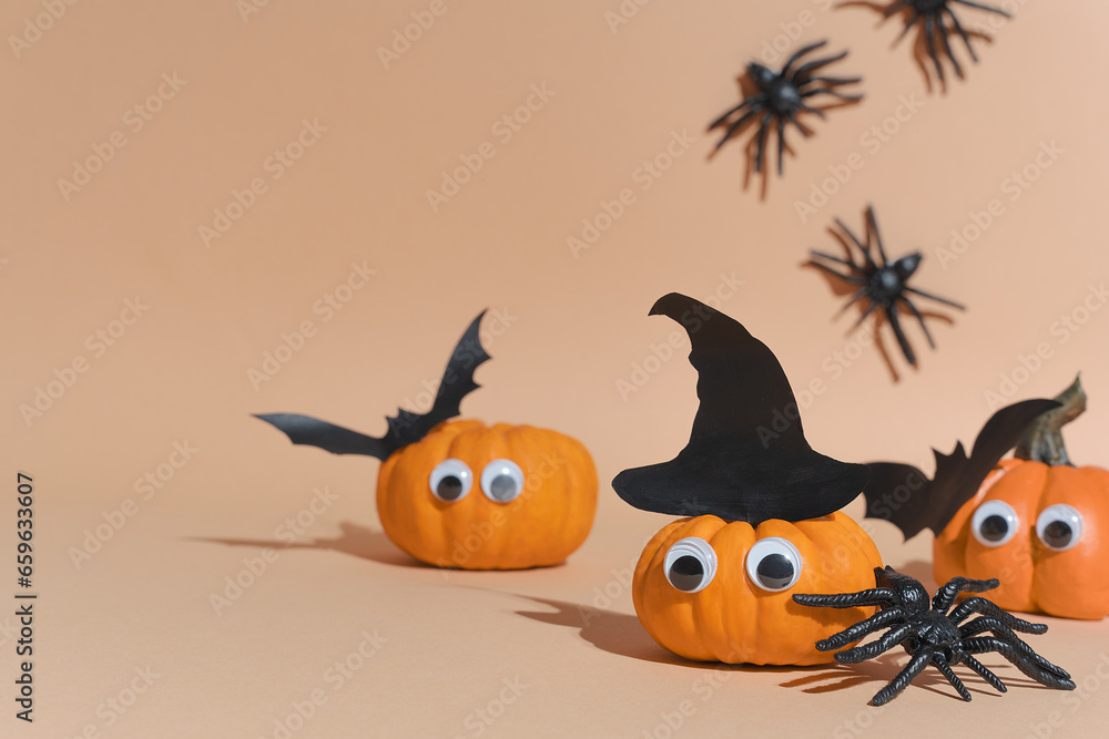 Naklejka premium Halloween banner. Decoration for Halloween party - cute pumpkins with eyes and funny faces. Set pumpkin monsters and crawling spiders. Copy space, art activity for kids, diy master class, promotion.