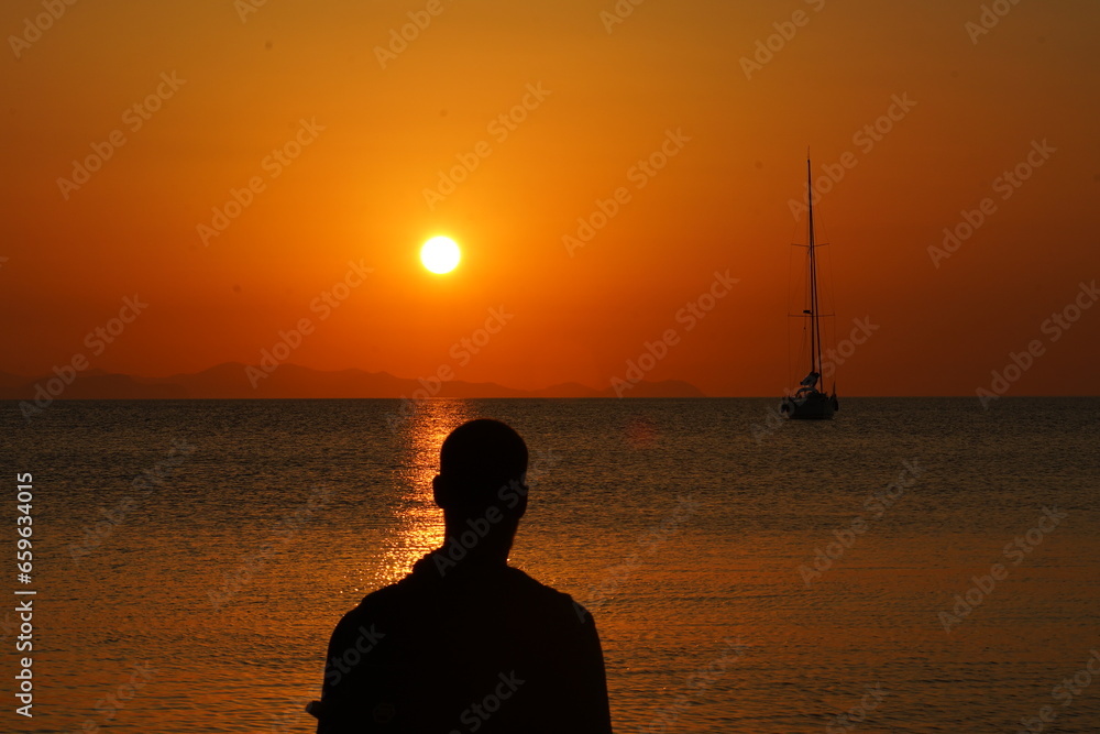 Silhouette of Man Watching the Sunset over the Sea