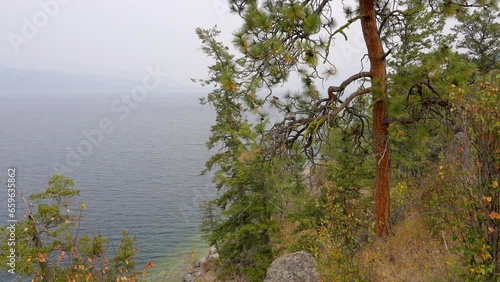 Establishing shot of Mountain Lake with Dramatic Smoke in Vancouver, Canada, North America. Day time on May 2023. Still camera view. ProRes 422 HQ. Ellison Provincial Park. photo