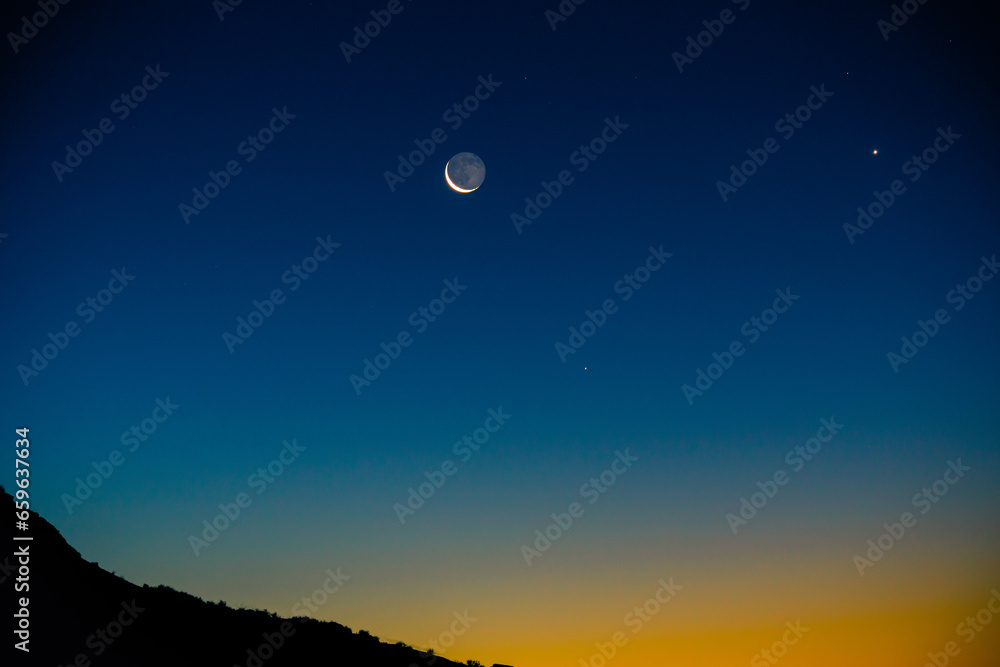 Crescent moon at twilight with the morning star Venus. Crescent moon at twilight with the morning star Venus.