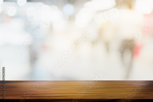 Wooden board empty table blurred shpping mall background.