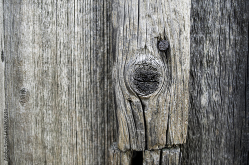 Close-up view of old wooden plank with knot. Grey boards. Grey wooden background. Textured.