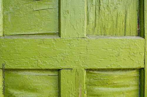 Close-up view of old door with green paint. Green boards. Texture background.