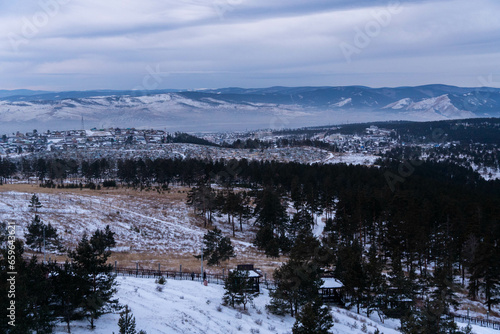The winter panorama view on the snow-covered Siberia hills and forest in proximity of the Buddhist temple in Ulan-Ude, Buryatia, Russia.