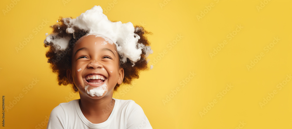 banner copyspace Little smiling african American child boy with big soap foam on head in hair on solid yellow background, Kids hygiene, Shampoo, hair treatment and soap for children, Kids bathing time - obrazy, fototapety, plakaty 