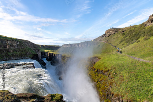 Panoramic view over the canyon of the Hv  t   river at end of Gullfoss waterfall located in southwest Iceland with tourist on viewpoint above