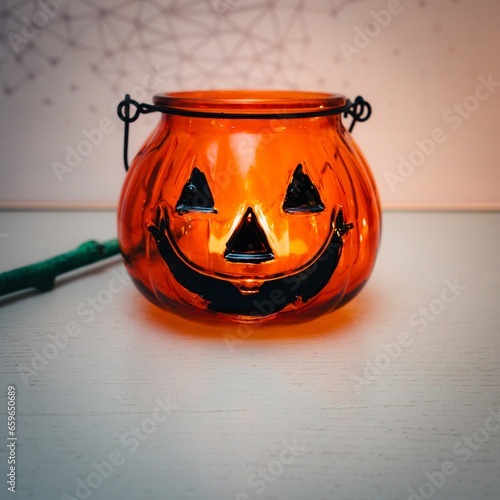 Decoration for Halloween. View of an orange pumpkin shaped glass.
