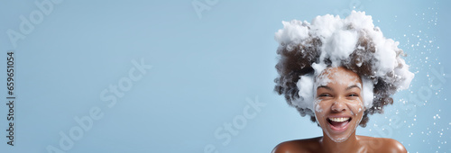  banner portrait beautiful african American model girl with big soap foam on head in hair on solid blue background, hygiene, Shampoo, hair treatment and soap, bathing time , copyspace . photo