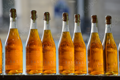 Bottles of cider in the window of a bakery in Paris