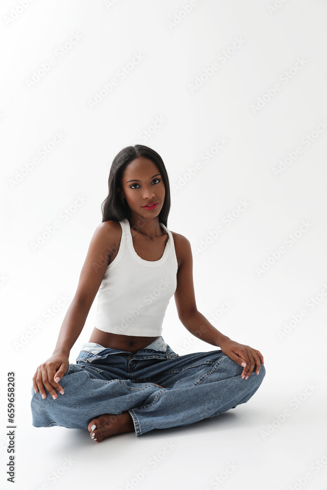 Gorgeous young lovely woman with dark skin wears casual clothing isolated. Vertical. Gorgeous young lovely woman with dark skin wears casual clothing isolated. Vertical.