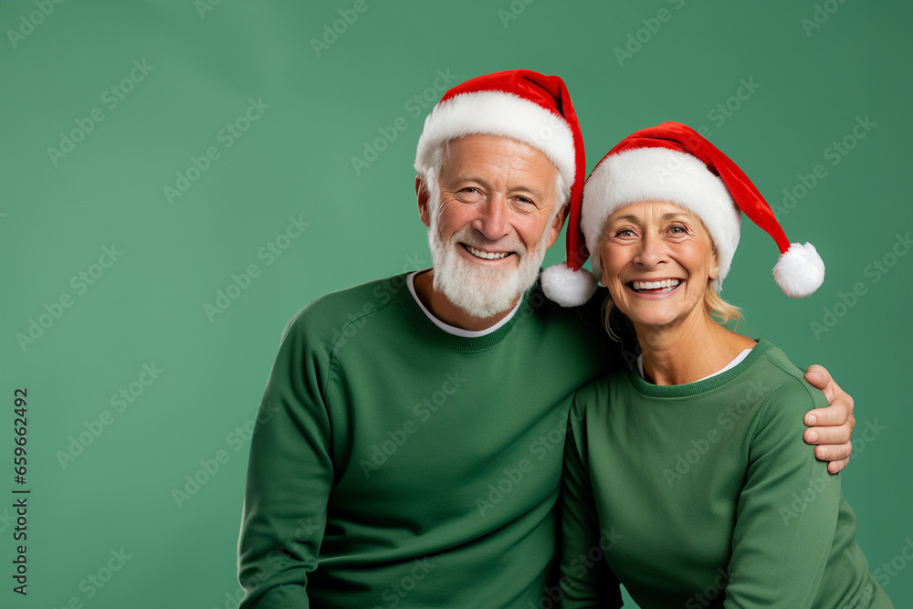 Grandfather and grandmother in Santa hats hugging each other. Older couple wearing Christmas outfits and standing against a pastel green background. Mock -up
Grandfather and grandmother in Santa hats hugging each other. Older couple wearing Christmas outfits and standing against a pastel green background. Mock -up