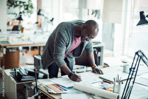 Young African American architect working on design in the office