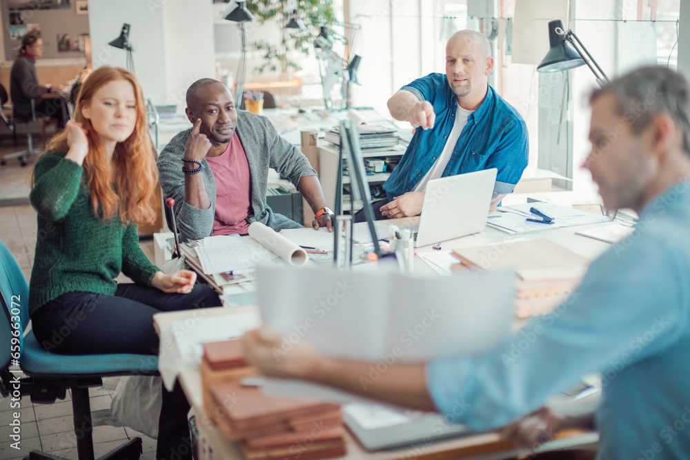 Group of people working together on a project in a startup company office Group of people working together on a project in a startup company office
