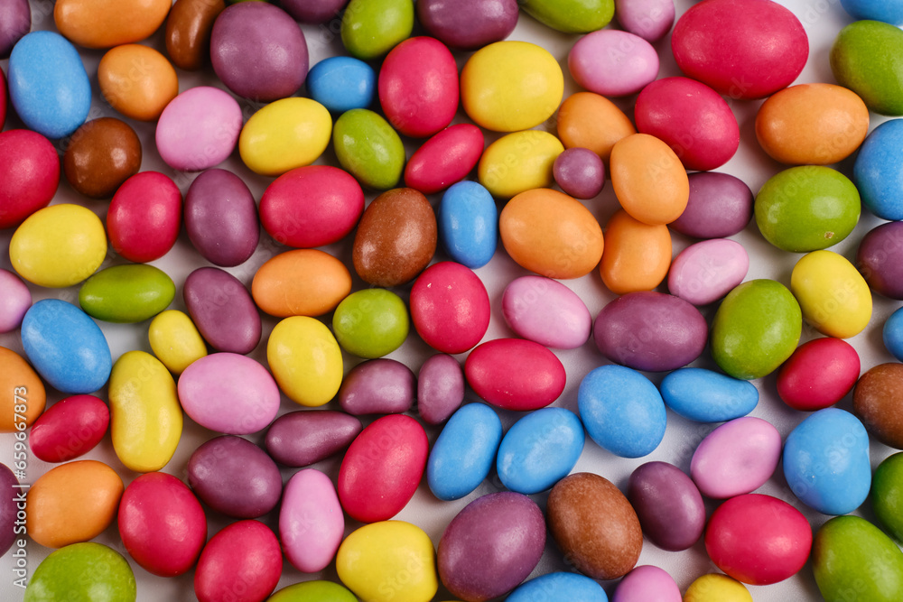 Multi-colored candies on a light background. Candy dragees. Candy background Multi-colored candies on a light background. Candy dragees. Candy background