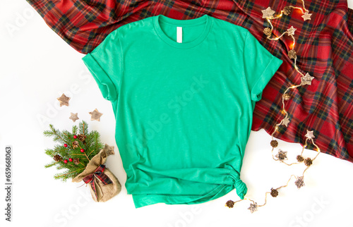 Flat lay mock up of heather green tshirt with Christmas accessories. X mas 3001 t shirt top view and white background photo