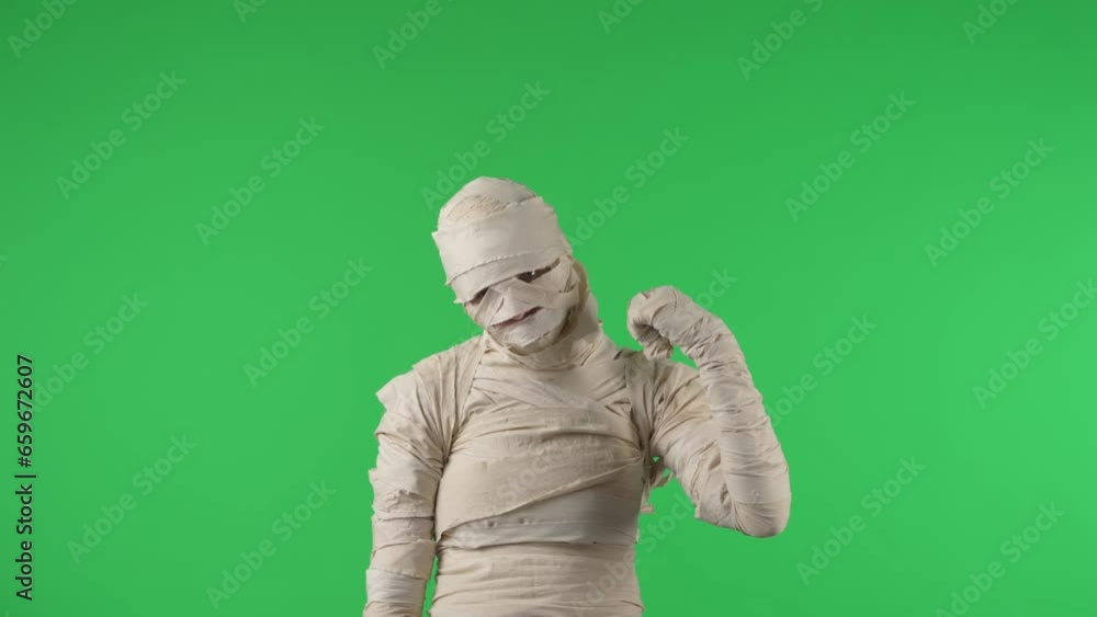 Green screen isolated chroma key video capturing a mummy pointing behind its back to encourage joining up, calling you. Green screen isolated chroma key video capturing a mummy pointing behind its back to encourage joining up, calling you.