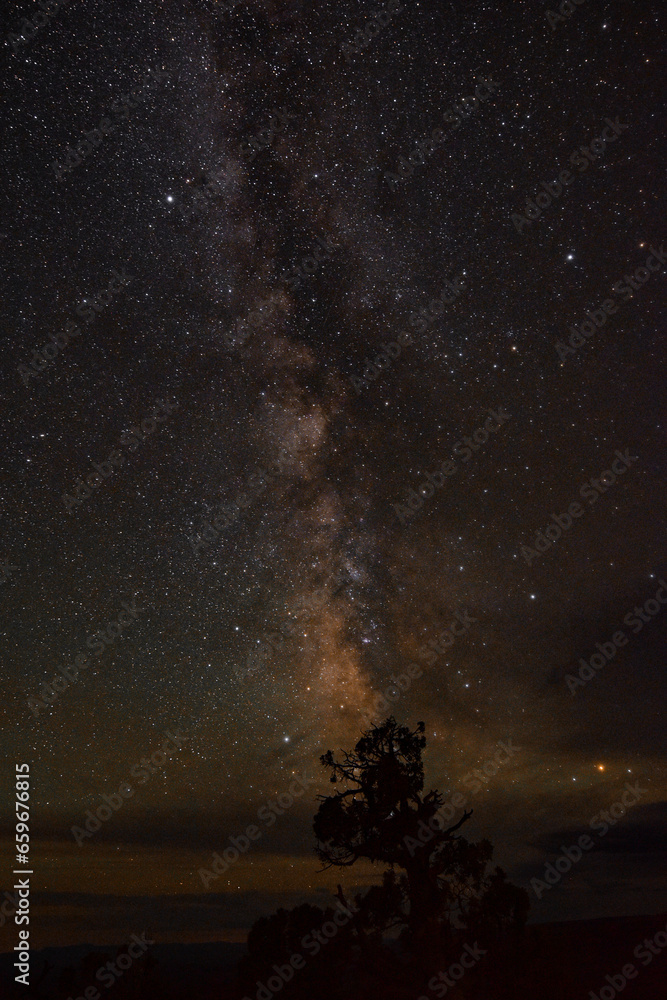 looking up at the night sky and seeing the milky way with clouds. 