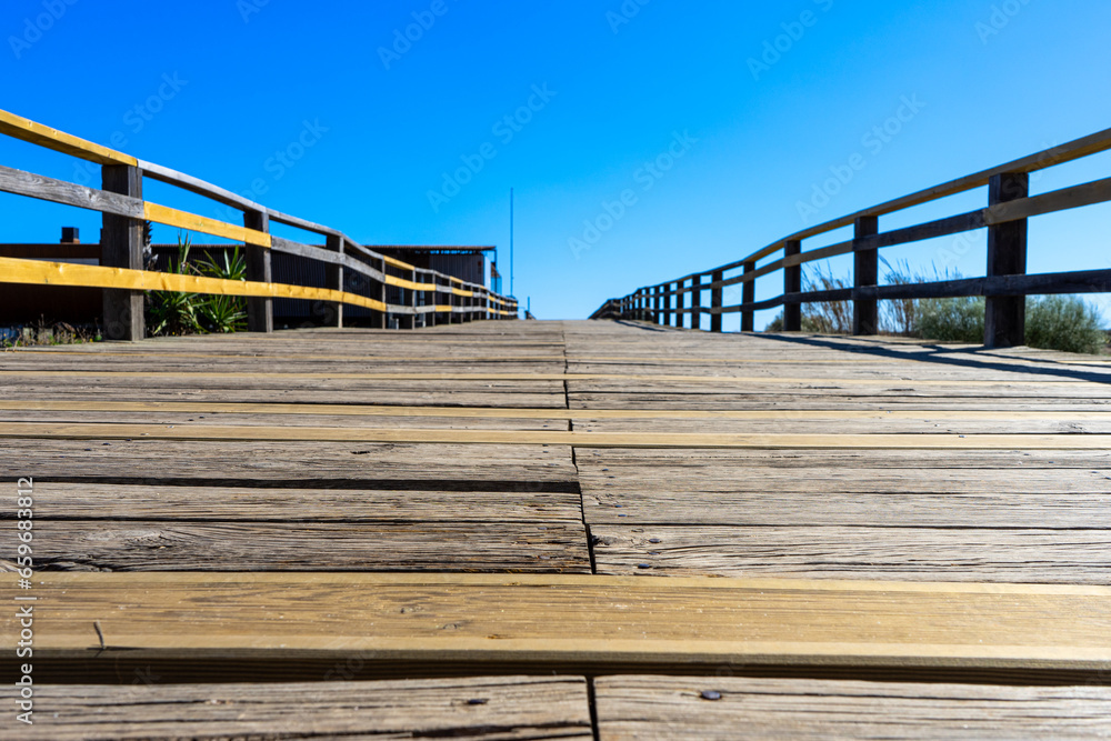 Obraz premium Wooden path to Manta Rota beach. West Atlantic coast of Algarve region, south of Portugal.